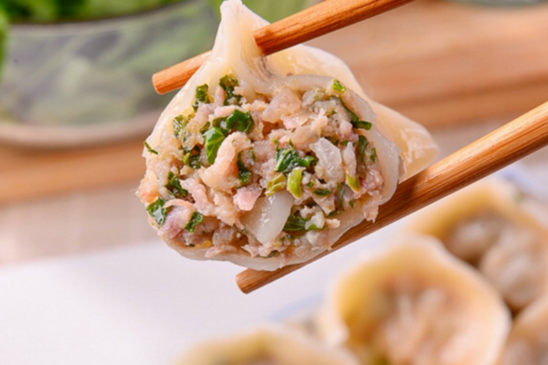 Photo of Joanne's dumplings held in chopsticks with vegetable and meat ingredients looking tasty