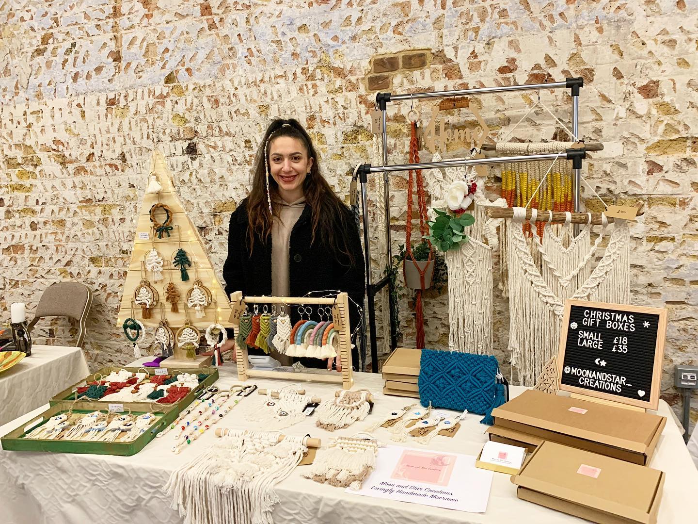 Sanel standing behind a stall of her beautiful macrame products